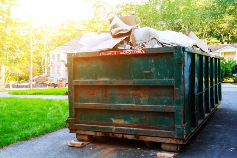 Green Dumpster Full of Trash